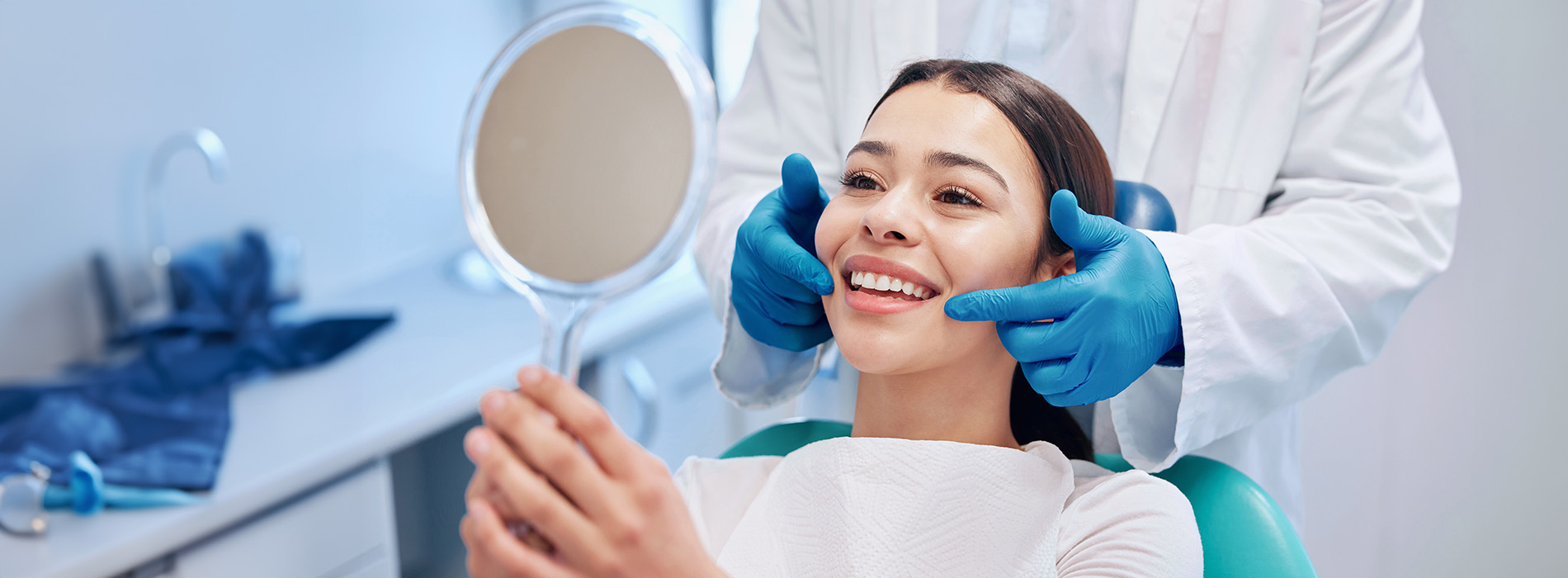 A person receiving dental care, with a dental professional performing an examination or procedure.