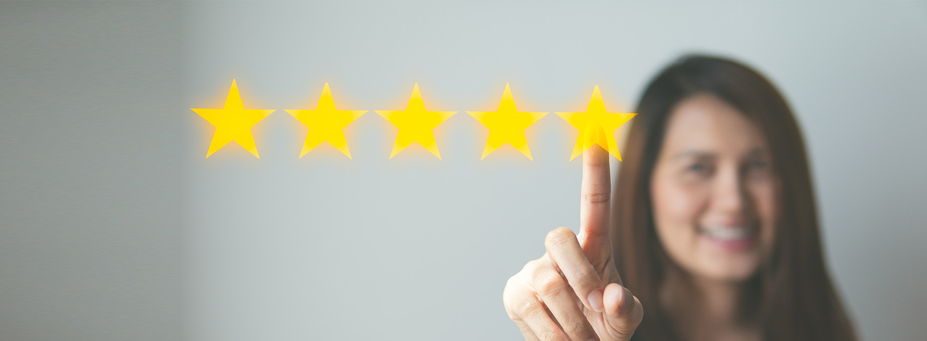 The image shows a person pressing a button with a star symbol on it, suggesting an action of approval or positive feedback.