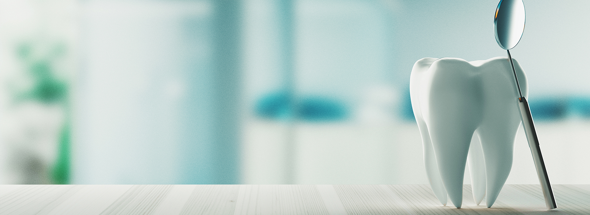 The image shows a dental implant model with a toothbrush in the background, placed on a surface that appears to be a table or countertop.