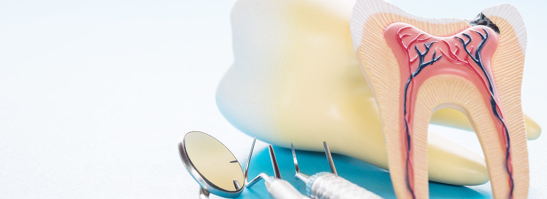 The image shows a toothbrush with a toothpaste tube on top, accompanied by dental floss and a dental mirror, all set against a blue background.